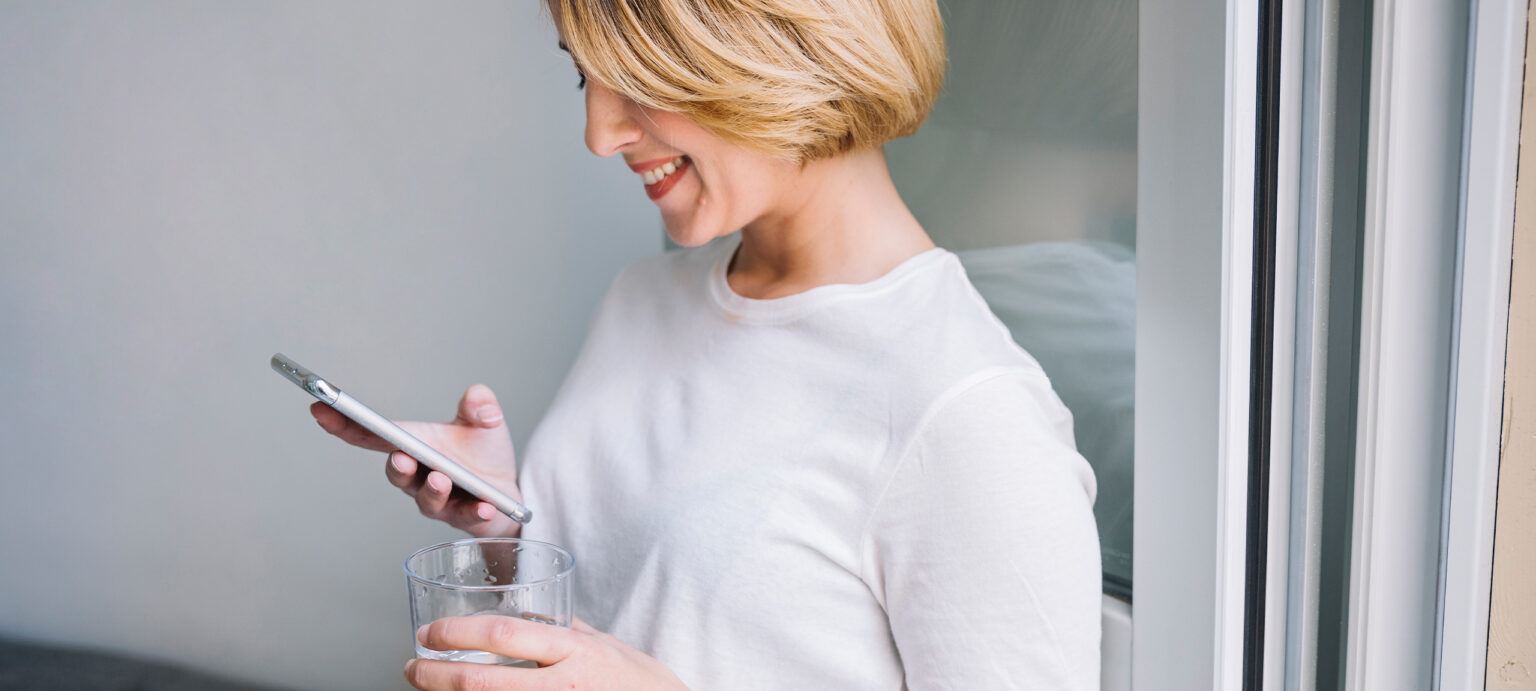 Woman scrolling on phone and clicking on top ranked site